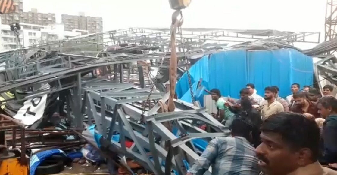 The public attempt to rescue people stuck under the iron hoarding in the Pimpri Chinchwad township in Pune on Monday. Photo: Screengrab