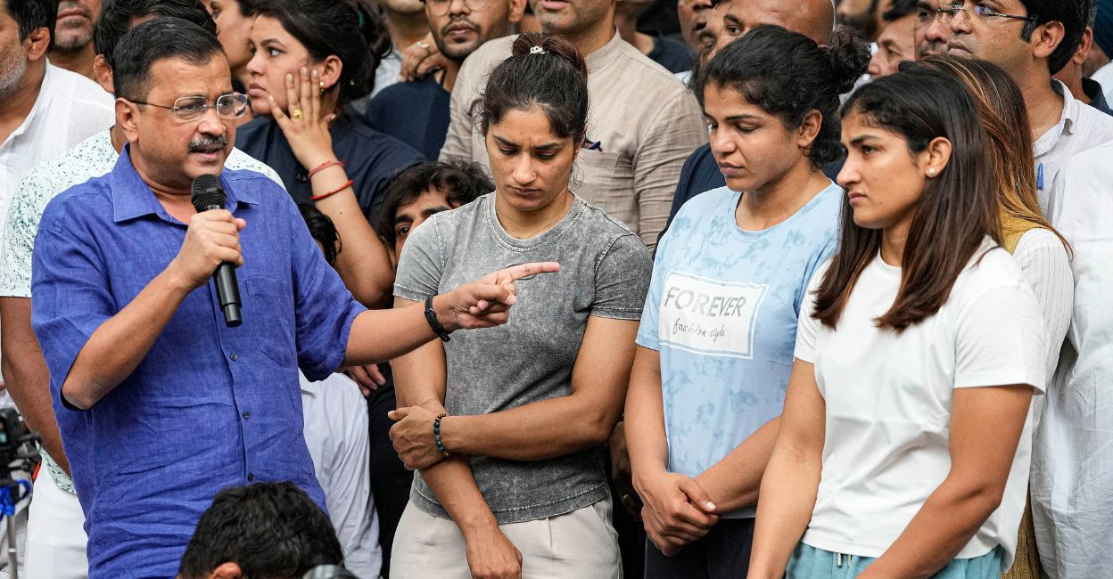 Delhi Chief Minister Arvind Kejriwal with wrestlers Vinesh Phogat, Sakshi Malik and Sangita Phogat during their protest at Jantar Mantar, in New Delhi, Saturday, April 29, 2023. Photo: PTI