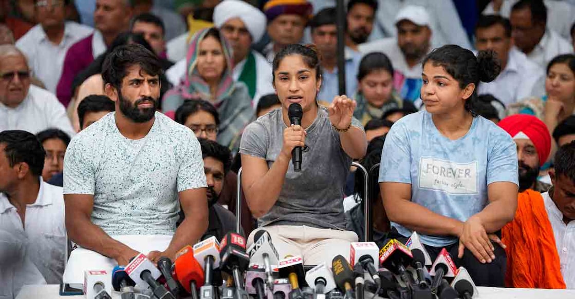 Wrestlers Bajrang Punia, Vinesh Phogat and Sakshi Malik speak with the media during their protest at Jantar Mantar, in New Delhi, Saturday, April 29, 2023. Photo: PTI