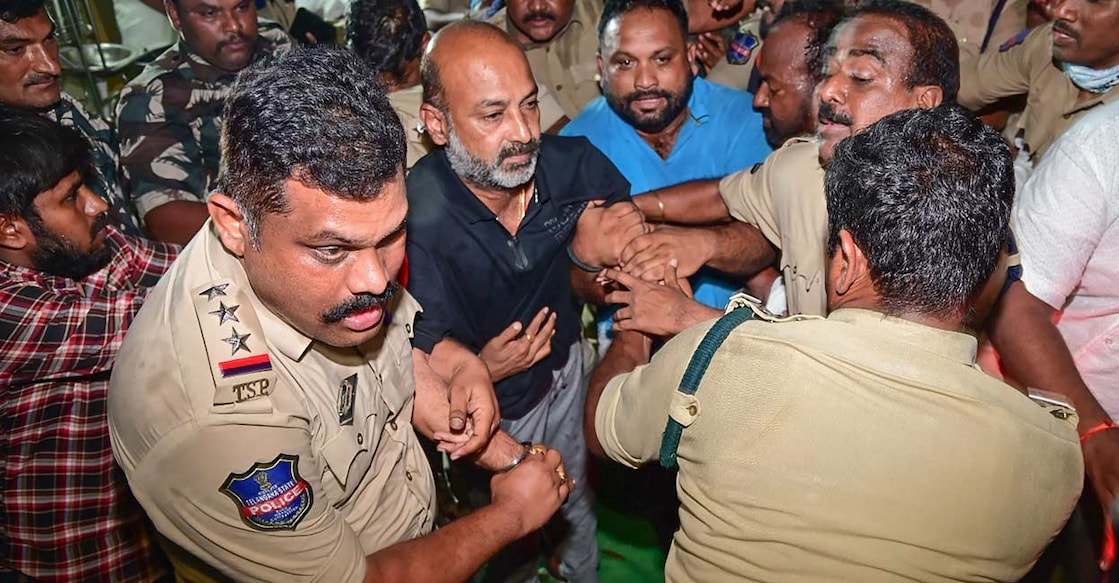 Telangana BJP President and MP Bandi Sanjay Kumar being detained by the police from his residence after midnight in Karimnagar. Photo: PTI 
