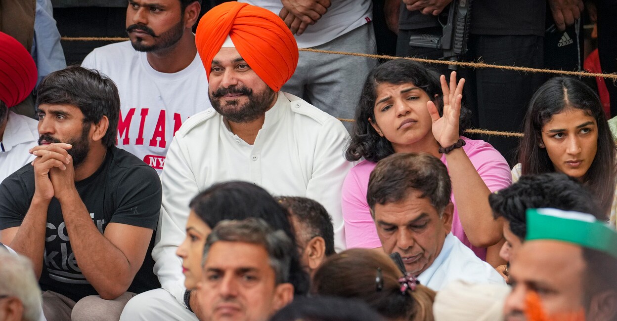 Congress leader Navjot Singh Sidhu with wrestlers Bajrang Punia, Sakshi Malik and others during the wrestlers' protest at Jantar Mantar in New Delhi on Monday. Photo: PTI
