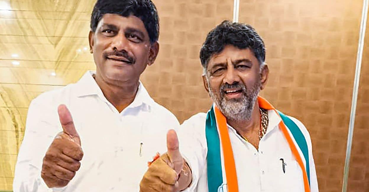 dk KPCC President D K Shivakumar with brother D K Suresh shows victory after party's decisive lead, in Bengaluru, Saturday, May 13, 2023. Photo: PTI