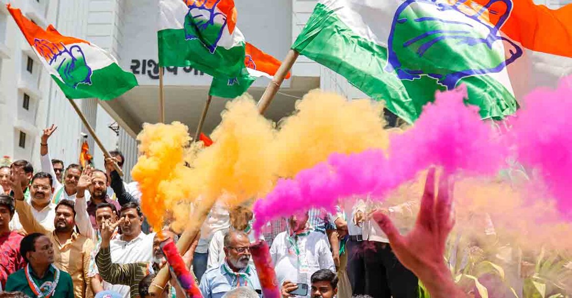 PTI05_13_2023_000141B Congress workers celebrate at the party office after the party's decisive lead in the Karnataka Assembly elections, outside Rajiv Gandhi Bhavan in Ahmedabad, Saturday, May 13, 2023. Photo: PTI