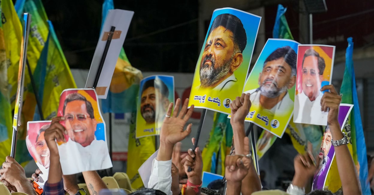 PTI05_14_2023_000347A Supporters of senior Congress leaders DK Shivakumar and Siddaramaiah outside the venue of the Congress Legislature Party (CLP) meeting in Bengaluru on Sunday. Photo: PTI