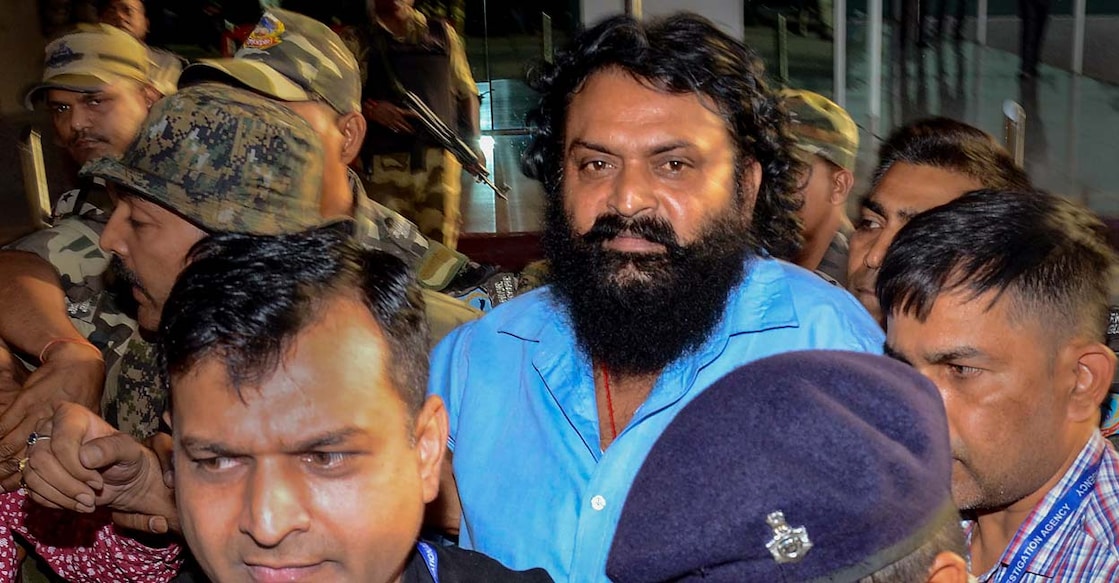 Dinesh Gope being brought after his arrest. Photo: PTI
