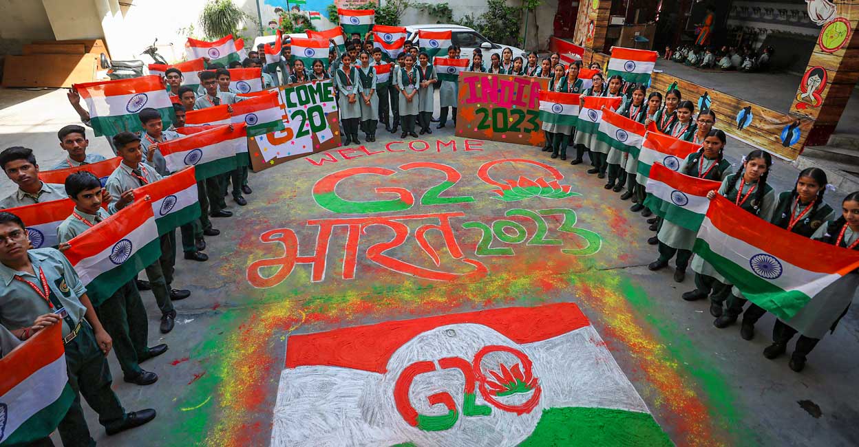 PTI05_22_2023_000038A Students make a 'rangoli' of G20 logo ahead of G20 meetings, in Srinagar, Monday, May 22, 2023. Photo: PTI