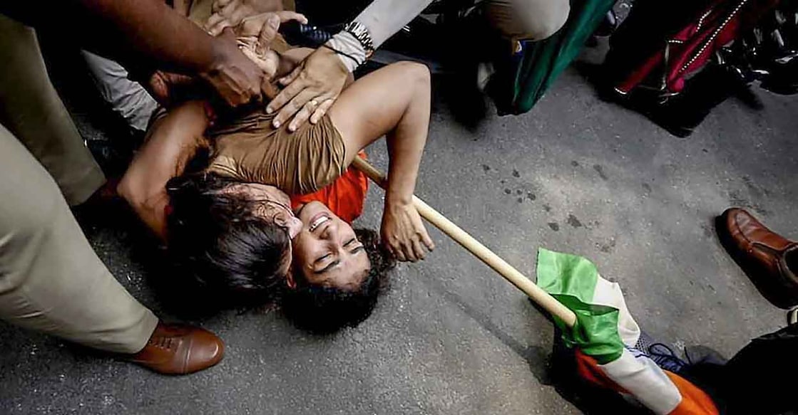 PTI05_28_2023_000160B Security personnel detain wrestlers Vinesh Phogat and Sangeeta Phogat during wrestlers' protest march towards new Parliament building, in New Delhi, Sunday, May 28, 2023. Photo: PTI