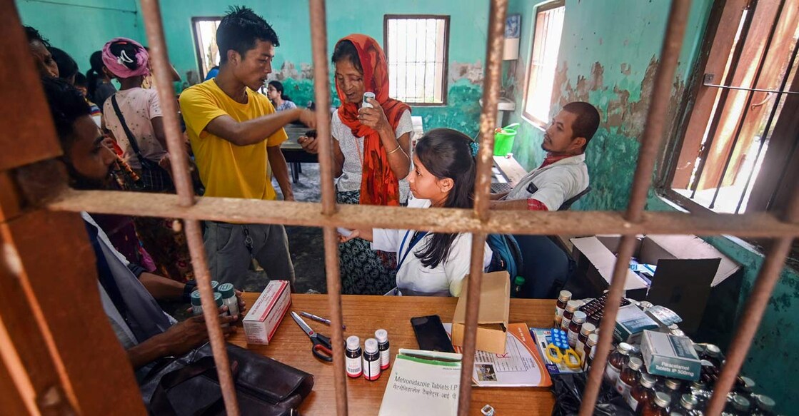 Health workers give free medicine to people from violence-hit areas of Manipur at a relief camp setup by the Assam Government. Photo: PTI
