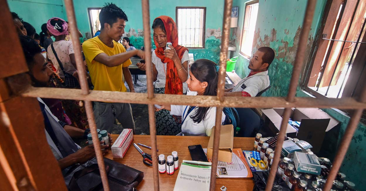 Health workers give free medicine to people from violence-hit areas of Manipur at a relief camp setup by the Assam Government. Photo: PTI