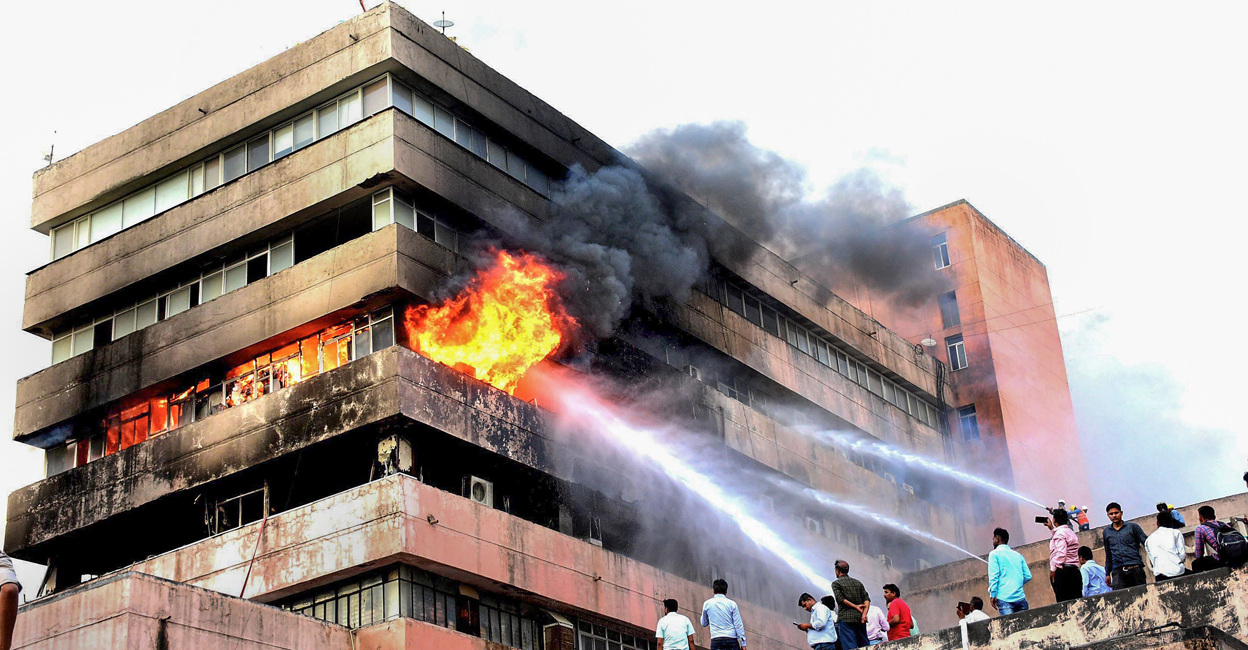 Firemen attempt to douse fire that broke out on the third floor of Satpura Bhawan, a building housing offices of various departments of the Madhya Pradesh government, in Bhopal on Monday. Photo: PTI