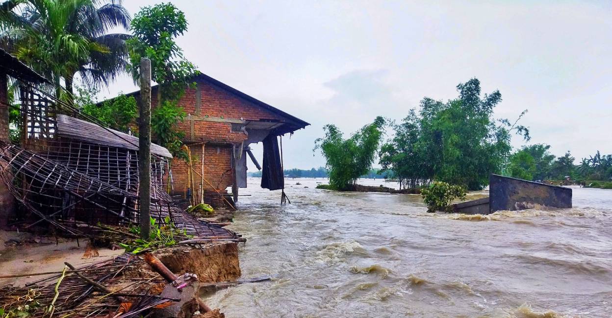 Assam flood **EDS: CORRECTS LOCATION** Lakhimpur: Several houses damaged as the flood water makes its way, in Lakhimpur district. Photo: PTI