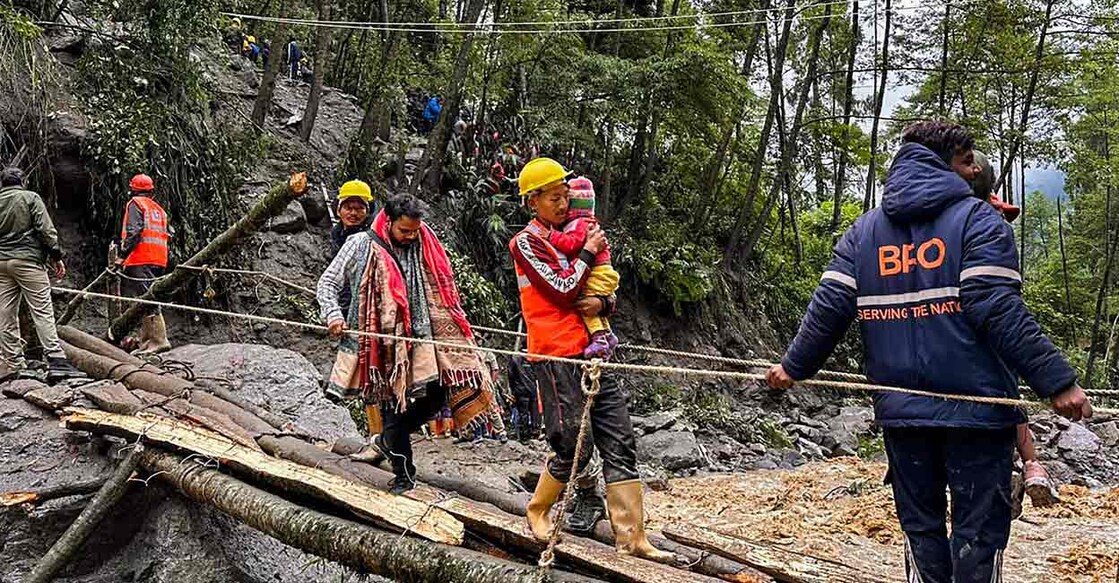 Tourists, who were stranded after a chunk of a road washed away following flash flood, being rescued by Border Roads Organisation teams in  Sikkim: Photo