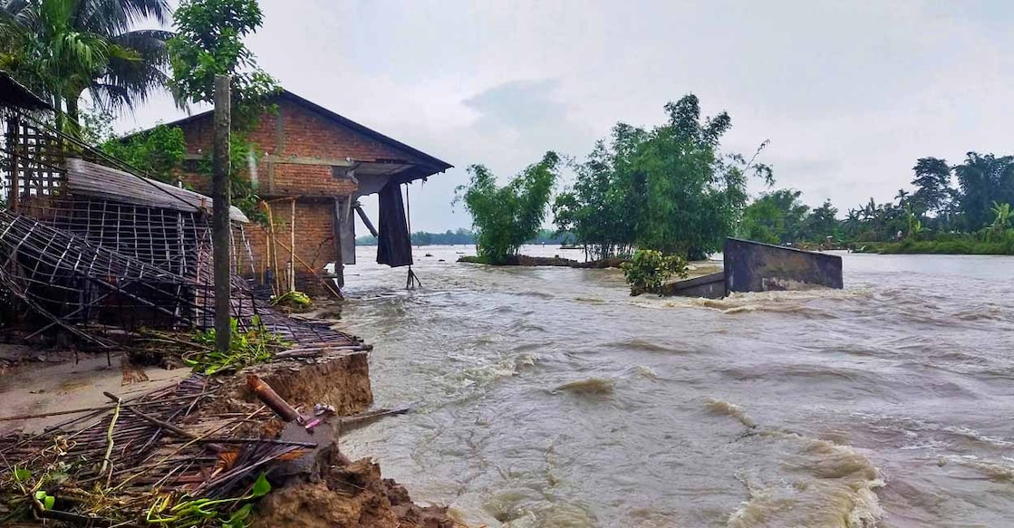 PTI06_16_2023_RPT167A Several houses damaged as the flood water makes its way, in Lakhimpur district, Assam. Photo: PTI