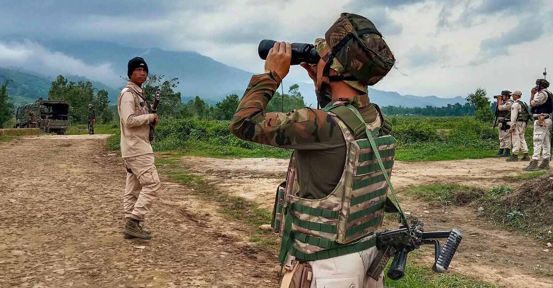 Security personnel patrol at a violence-hit area in Irengbam village of Bishnupur district. Photo: PTI