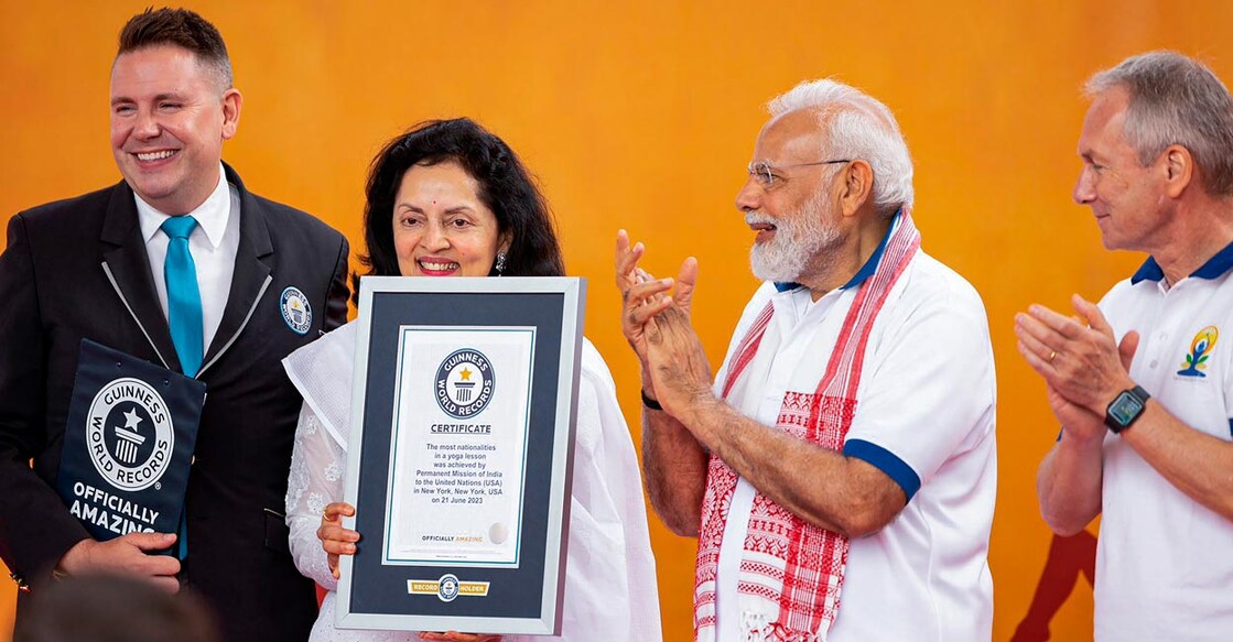 Prime Minister Narendra Modi applauds as India's Permanent Representative to the UN Ruchira Kamboj shows the Guinness World Records certificate award. Photo: PTI