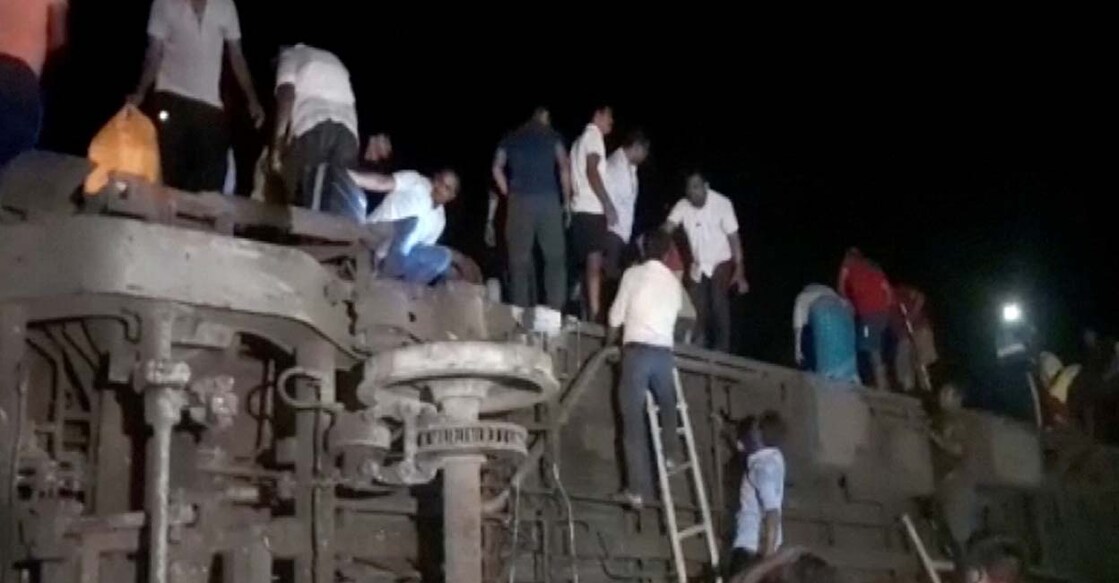 People try to escape from toppled compartments, following the deadly collision of two trains, in Balasore, India June 2, 2023, in this screen grab obtained from a video. ANI/Reuters TV via REUTERS