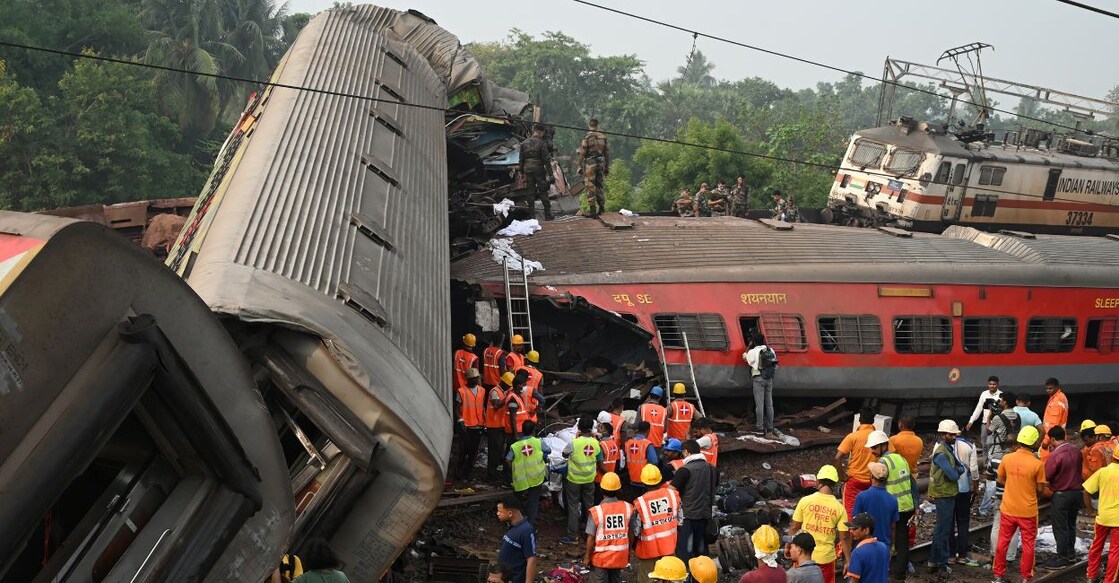 Rescue workers gather around damaged carriages at the accident site of a three-train collision near Balasore, about 200 km (125 miles) from the state capital Bhubaneswar in the eastern state of Odisha, on June 3, 2023. Photo: AFP