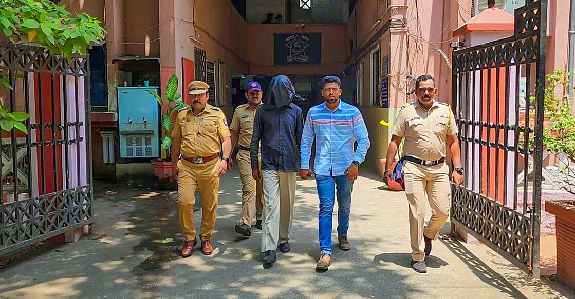 Police personnel take 56-year-old accused Manoj Sane into custody for allegedly chopped and boiled body parts of his live-in partner at Mira Road locality, in Thane district, Thursday, June 8, 2023. Photo: PTI
