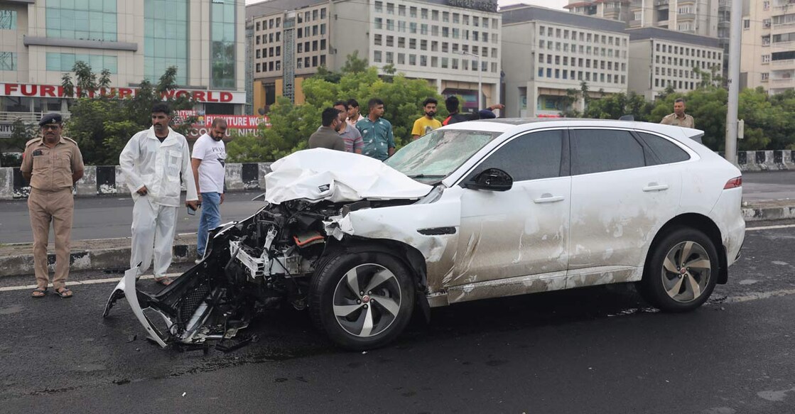 People stand near the wreckage of a vehicle after an accident in Ahmedabad. Photo: PTI
