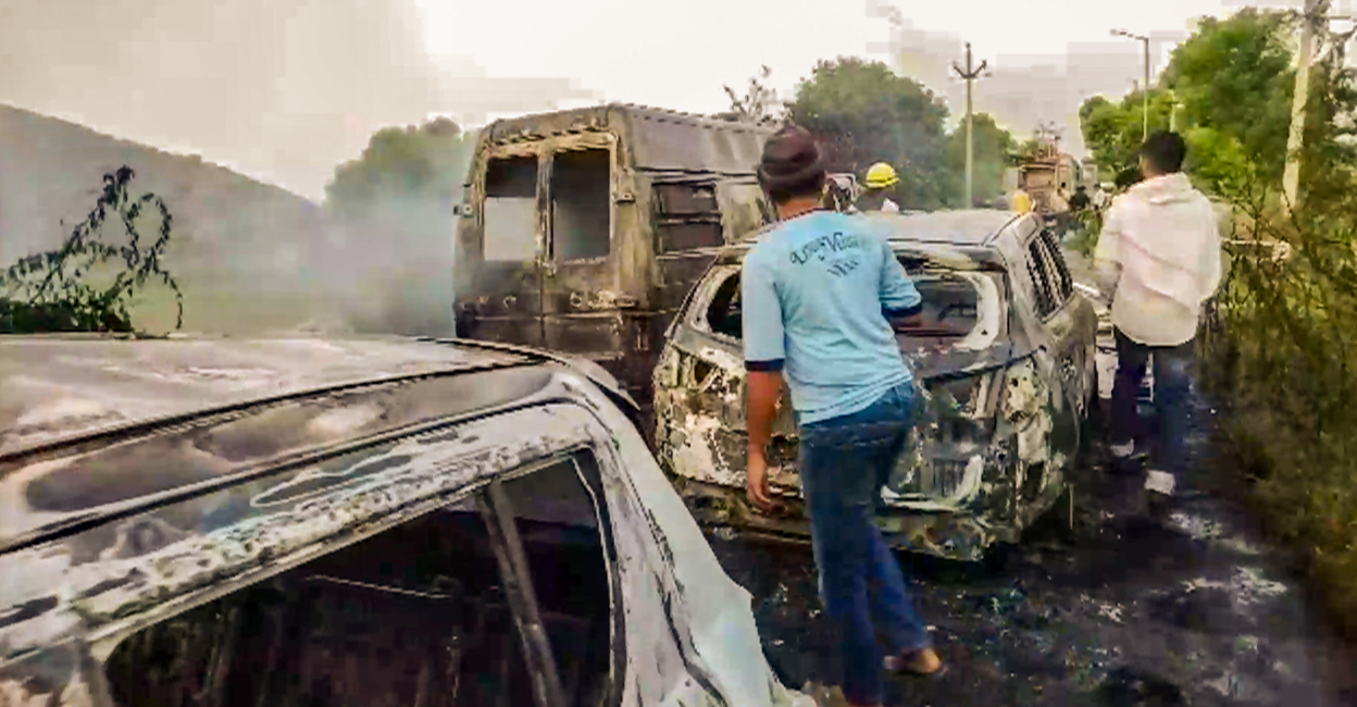 PTI07_31_2023_000229A People inspect the vehicles set on fire during clashes that broke out during a 'Brij Mandal Jalabhishek Yatra', in Nuh, Haryana on Monday. Photo: PTI