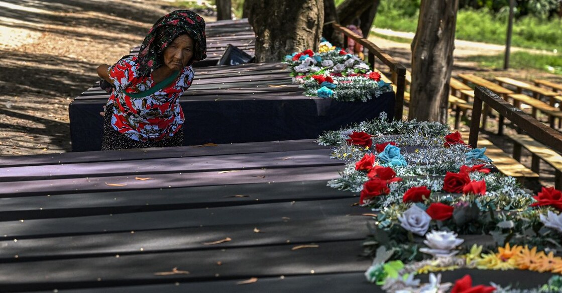 In this picture taken on July 24, 2023, an elderly woman looks at empty coffins kept at a makeshift memorial made for the victims who lost their lives during the ethnic violence in Churachandpur district in the northeastern state of Manipur. Photo: Arun Sankar/AFP