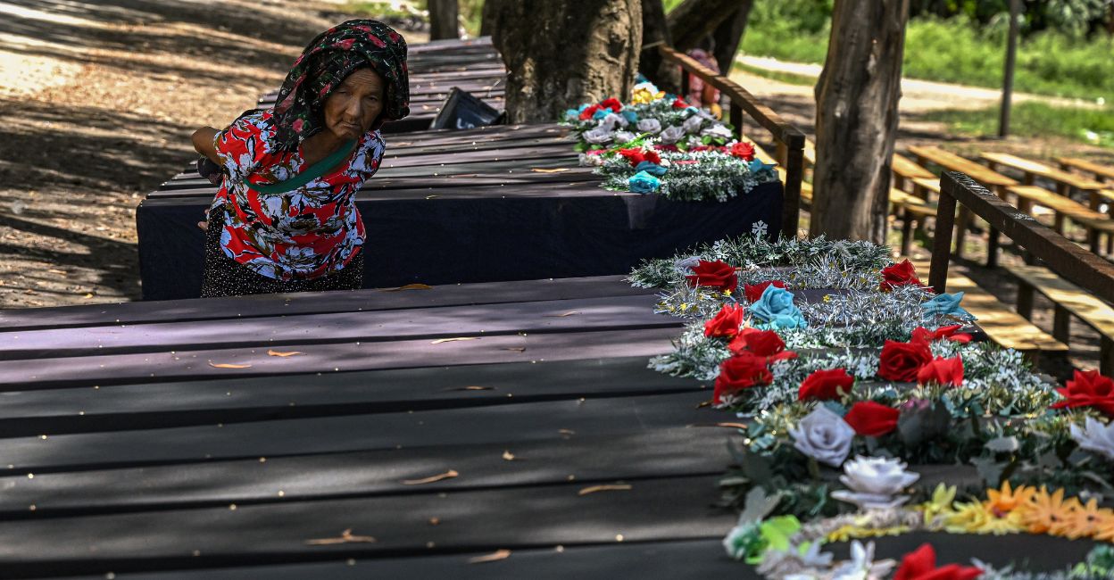 In this picture taken on July 24, 2023, an elderly woman looks at empty coffins kept at a makeshift memorial made for the victims who lost their lives during the ethnic violence in Churachandpur district in the northeastern state of Manipur. Photo: Arun Sankar/AFP