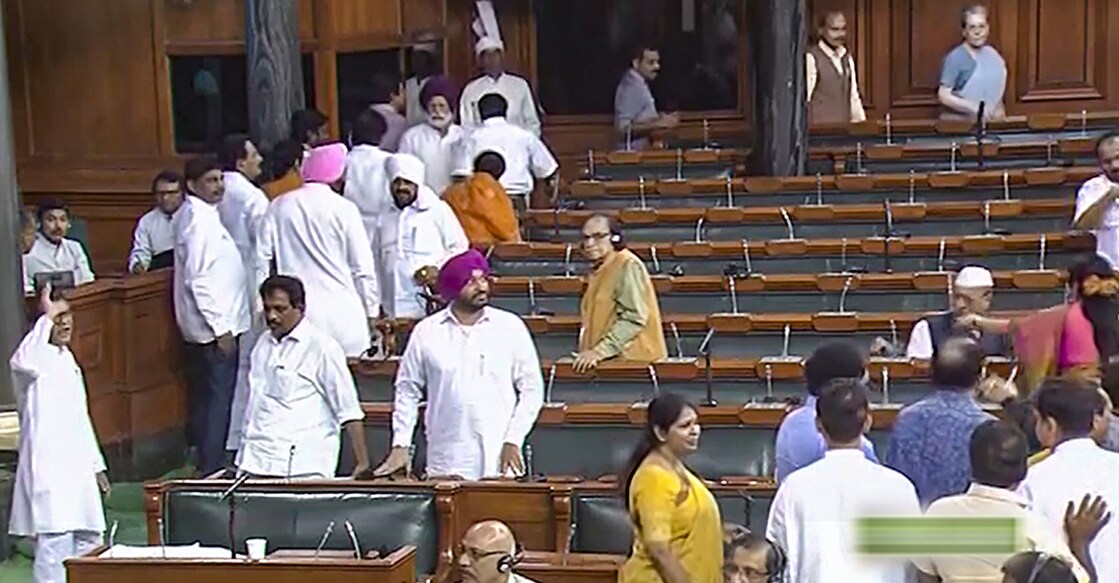 Opoosition members walk out of the Lok Sabha during the discussion on the Motion of No-Confidence, in the Monsoon session of Parliament, in New Delhi on Thursday. Photo: PTI