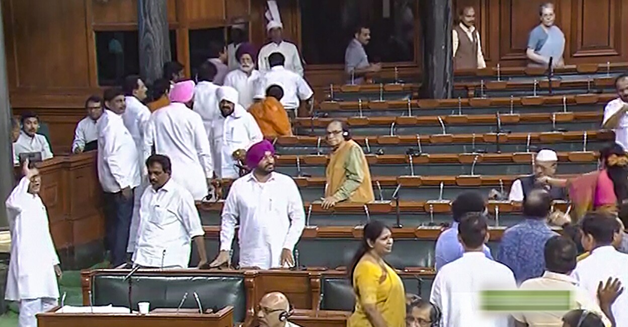 Opoosition members walk out of the Lok Sabha during the discussion on the Motion of No-Confidence, in the Monsoon session of Parliament, in New Delhi on Thursday. Photo: PTI