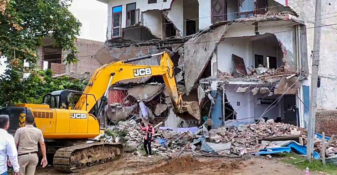 Bulldozer being used to demolish the 'illegally constructed' Sahara hotel in violence-hit Nuh district. Photo: PTI