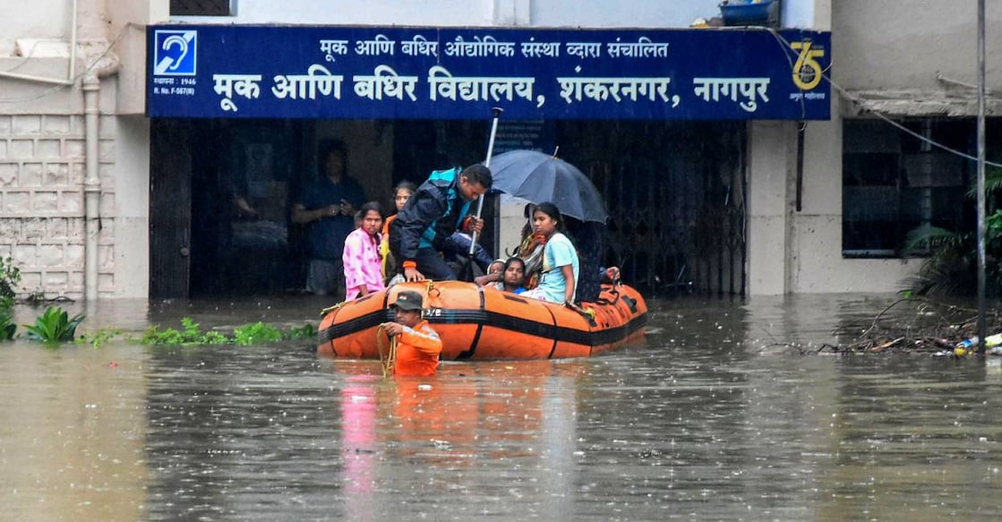 NDRF personnel rescue children from a flooded school after heavry rains in Nagpur. Photo: PTI