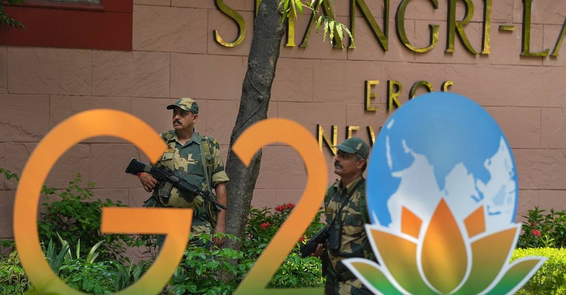 g20-summit-c Security officials stand guard near a G20 Summit logo installed at Shangri-La Hotel as part of preparations for the upcoming summit, in New Delhi. Photo: PTI
