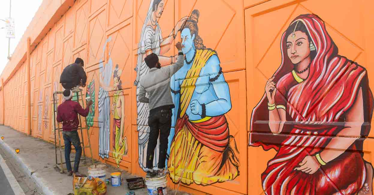 Artists make a graffiti depicting Lord Ram and Goddess Sita on the wall of an overbridge ahead of the Jan. 22 consecration of the Ram Mandir, in Ayodhya, Monday, Jan. 8, 2024. Photo: PTI