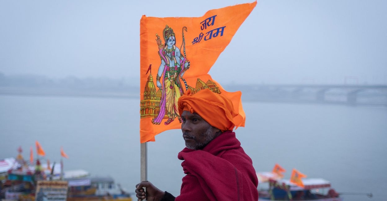 ayodhya-ram-temple-1 A Hindu devotee carries a flag with a picture of Lord Ram on the banks of the Sarayu River after taking a holy dip, ahead of the opening of the temple of Lord Ram in Ayodhya, India, January 20, 2024. Photo: Reuters/Adnan Abidi