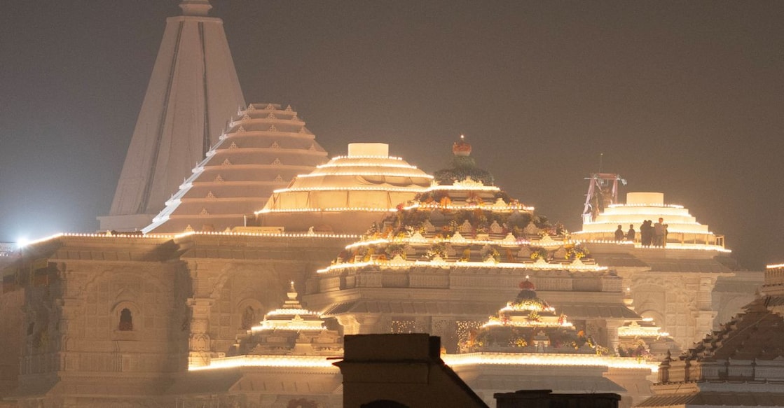 Labourers stand on top of the illuminated grand temple of Lord Ram ahead of its opening in Ayodhya in India, January 19, 2024. Photo: Reuters/Adnan Abidi