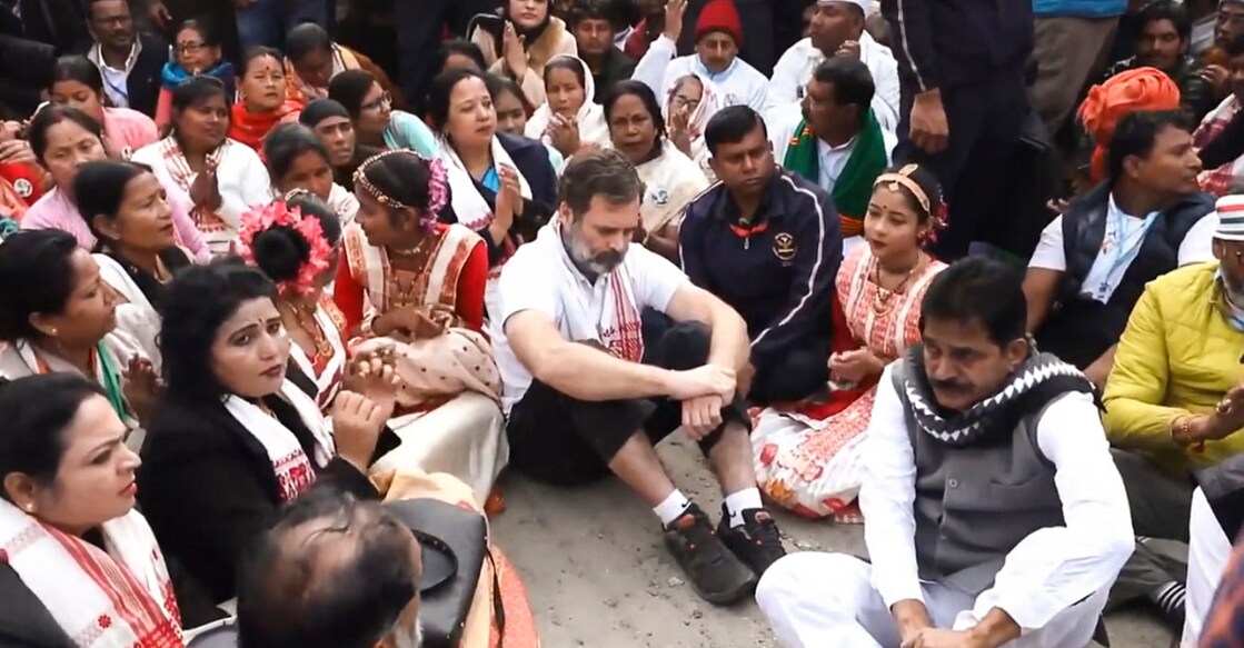 PTI01_22_2024_000036A Congress leader Rahul Gandhi with party leaders and supporters sits in protest after he was not allowed to visit the Sri Sri Sankar Dev Satra during the Bharat Jodo Nyay Yatra, in Nagaon district, Assam. Photo: PTI.