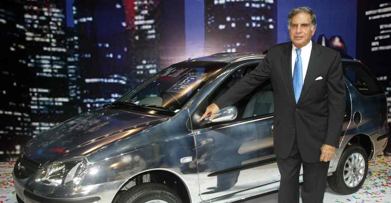 INDIA Ratan Tata, chairman of Tata Motors Ltd, poses with company's new estate version Indigo 'Marina' car, during its launch in Bombay September 15, 2004. File photo: REUTERS/Punit Paranjpe