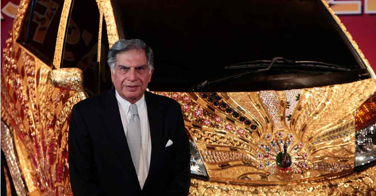 INDIA Chairman of Tata Group Ratan Tata poses in front of a Nano car made of gold during a ceremony in Mumbai September 19, 2011. File photo: REUTERS/Danish Siddiqui