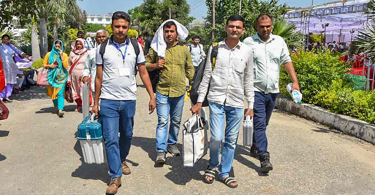 Polling officials with EVMs and other election material leave for their respective polling stations on the eve of the Haryana Assembly elections, in Sonipat, Haryana, Friday, Oct 4, 2024.  Photo: PTI