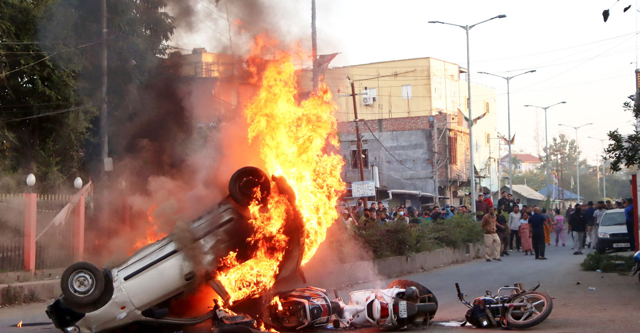 Smoke and flames billow out of vehicles which were set on fire during protests. Photo: PTI