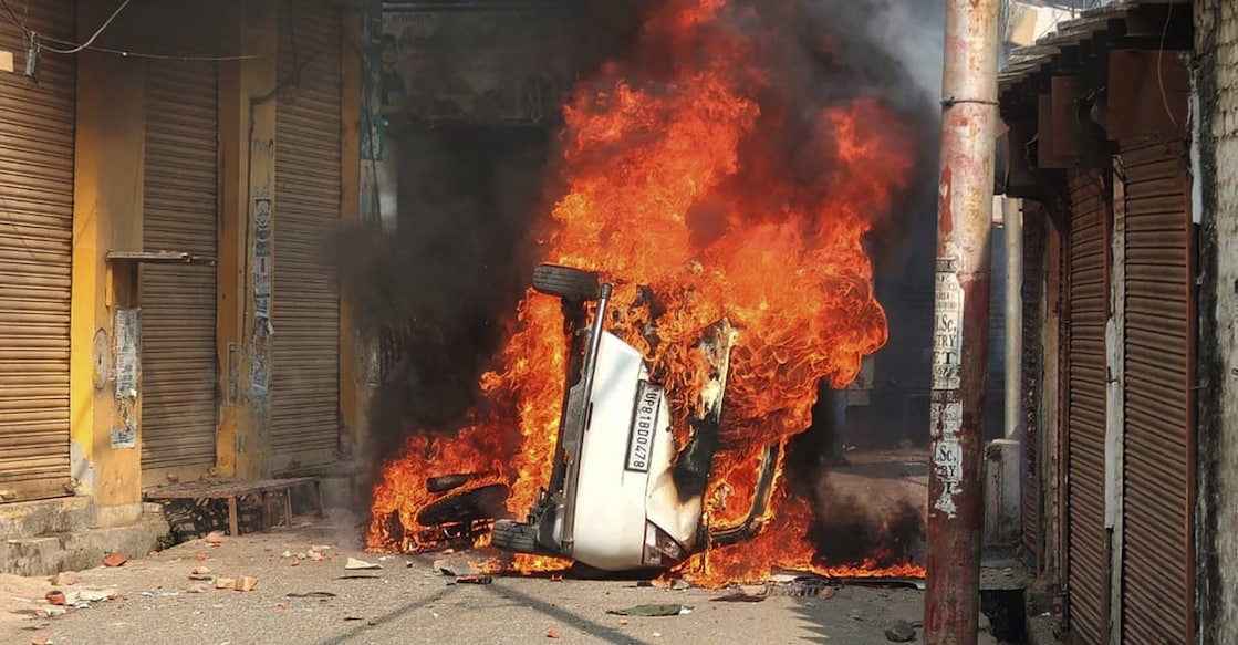 A vehicle burns during a clash between protesters and police in Sambhal, in the northern Indian state of Uttar Pradesh, Sunday, Nov. 24, 2024. Photo: PTI.
