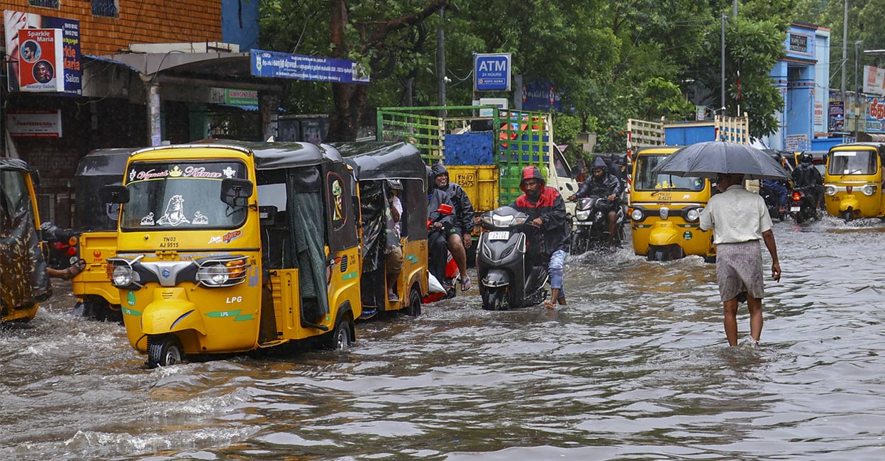 Vehicles move on a waterlogged road amid rain owing to Cyclone Fengal in Chennai on Saturday, November 30, 2024. Photo: PTI.