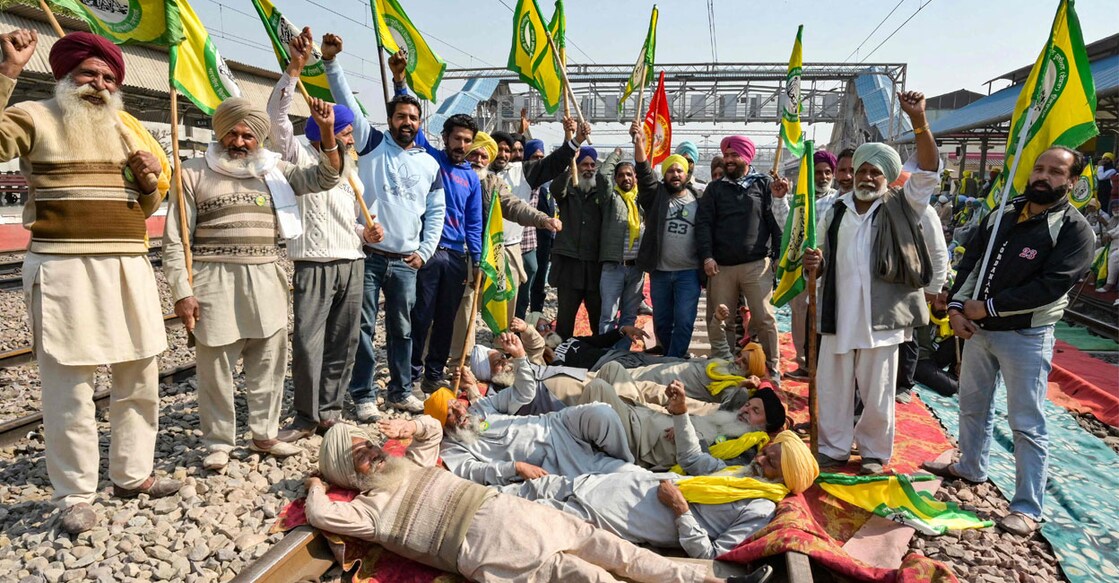 Members of the farm union Bharatiya Kisan Union (Ekta Ugrahan) block railway tracks and shout slogans during a protest to demand minimum crop prices at a railway station in Rajpura on February 15, 2024. Photo: PTI.