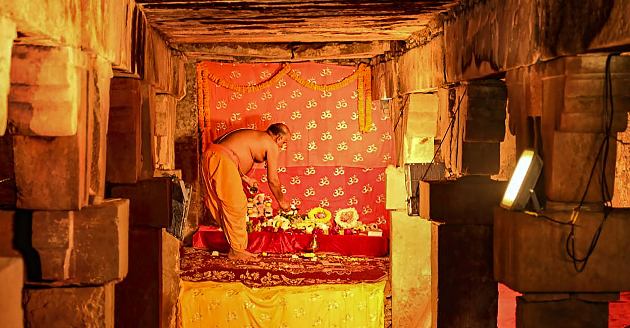 A priest performs prayers in the basement of Gyanvapi mosque following court orders allowing the resumption of the practice that was discontinued three decades back, in Varanasi, late Wednesday night, Jan. 31, 2024. Photo: PTI.