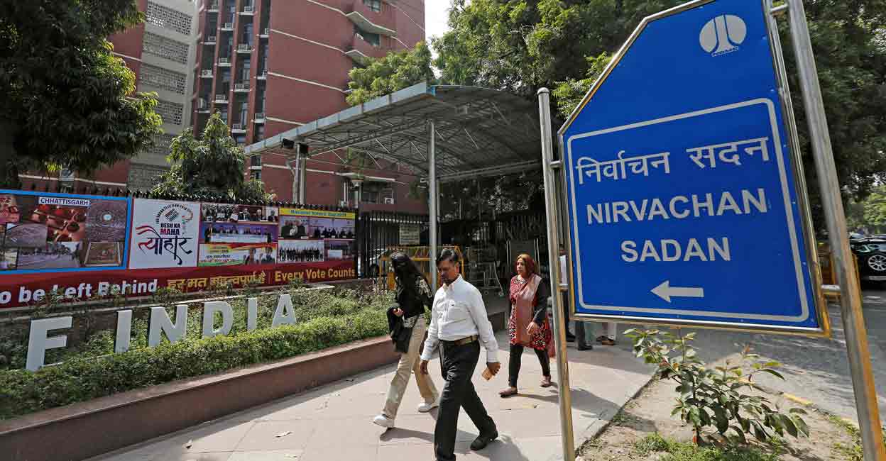 People walk past the Election Commission of India office building in New Delhi, India March 11, 2019. File Photo: REUTERS/Adnan Abidi