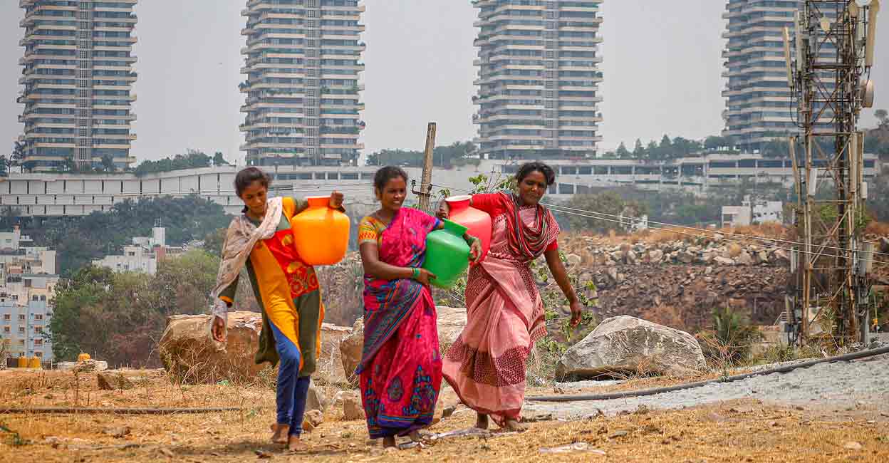 Women carry water pots amid the ongoing water crisis, in Bengaluru, Thursday, March 14, 2024. Photo: PTI