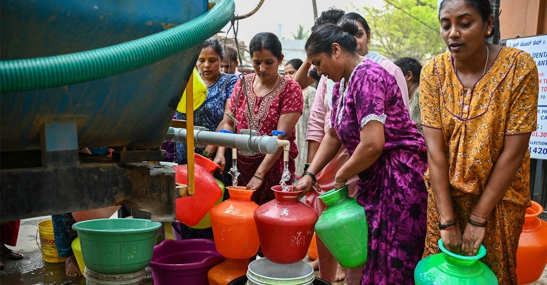 Residents collect free water from a municipal tanker amidst the ongoing water crisis in Bengaluru on March 15, 2024. Photo: PTI. 
