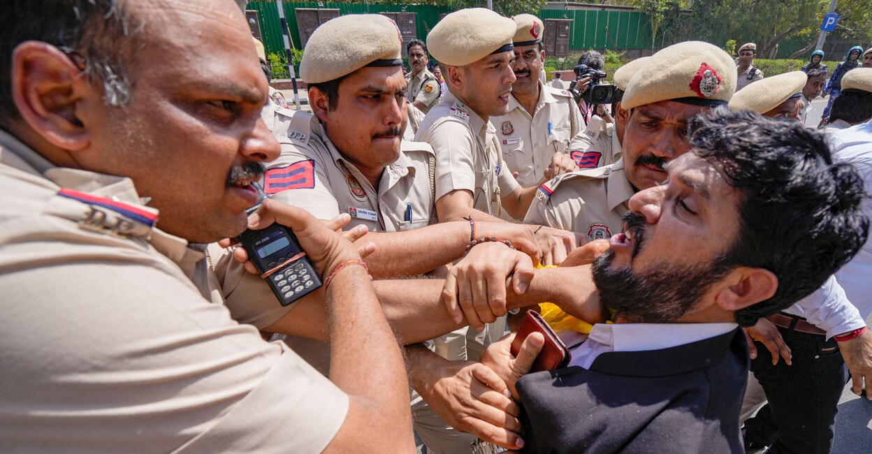 PTI03_23_2024_000163A Police detain an AAP supporter during a protest at the Shaheedi Park over the arrest of Delhi Chief Minister Arvind Kejriwal, in New Delhi on Saturday. Photo: PTI