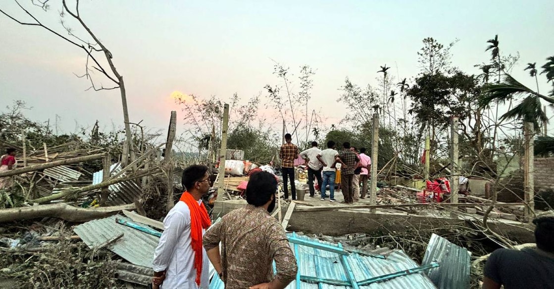 storm-bengal-c Houses are damaged and electric poles fell after a heavy strom in Jalpaiguri. Photo: PTI