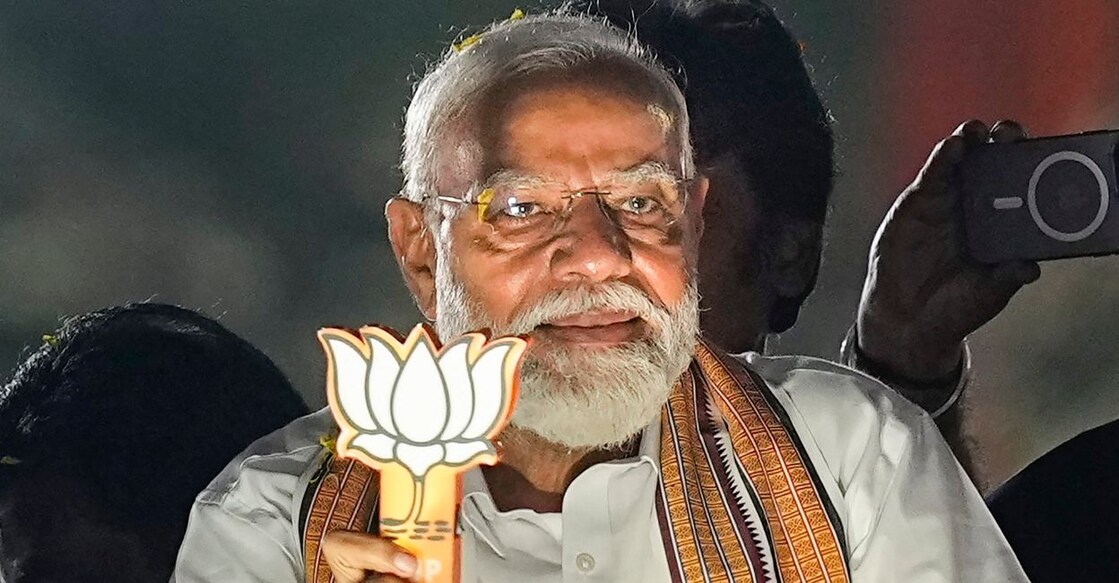 Prime Minister Narendra Modi greets supporters during a roadshow in support of BJP's candidate from South Chennai constituency Tamilisai Soundararajan, ahead of the Lok Sabha election, in Chennai, Tuesday, April 9, 2024. Photo: PTI
