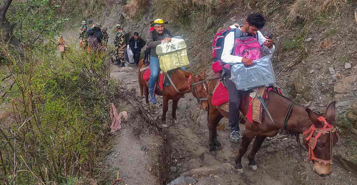 PTI04_18_2024_000164B Security personnel and polling officials with EVMs and other election material leave for election duty ahead of the first phase of voting for Lok Sabha elections, in Doda, Thursday, April 18, 2024. Photo: PTI